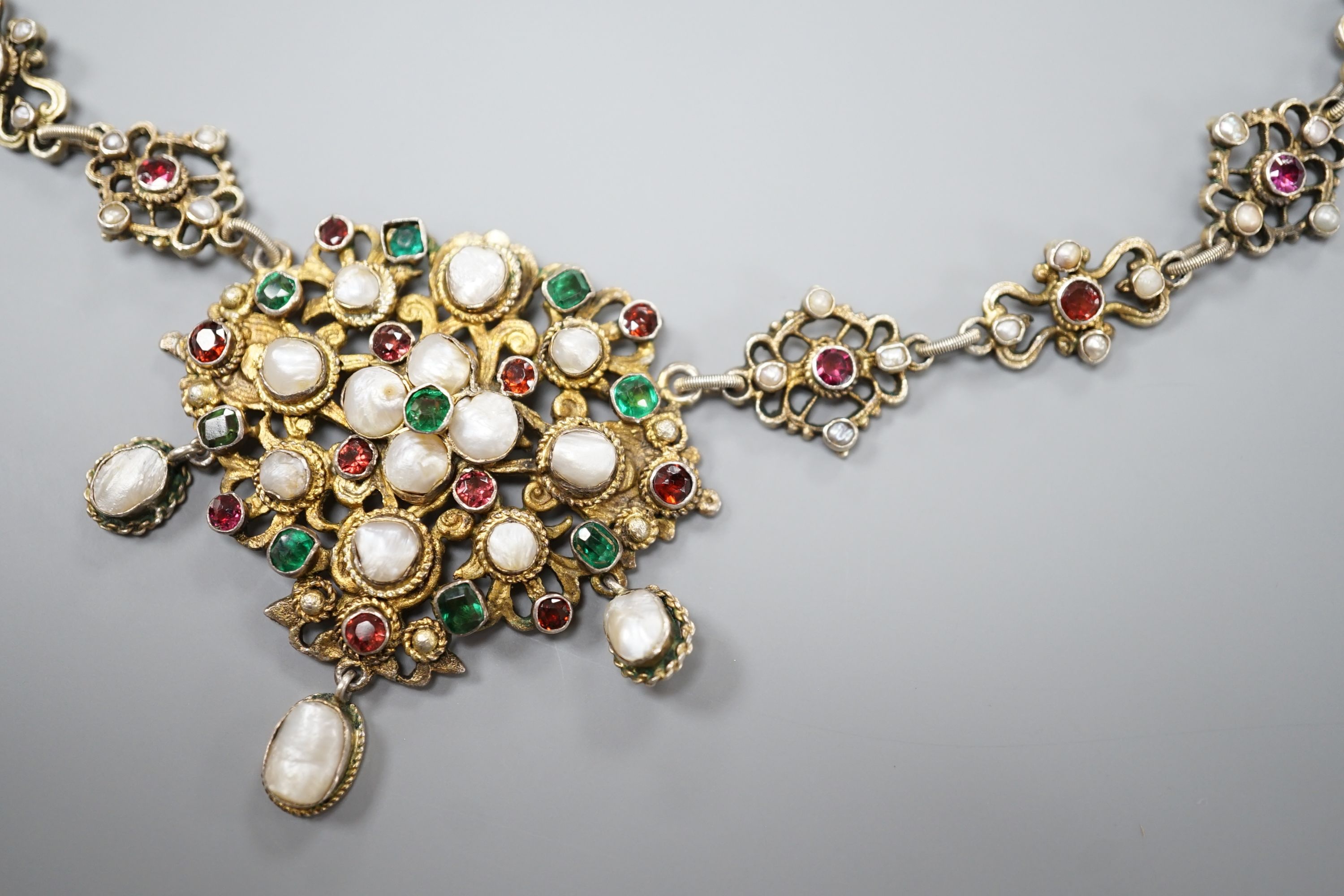 An ornate 19th century Austro-Hungarian gilt white metal, baroque pearl, paste and gem set drop necklace, 46cm, maker's mark WH or WM.